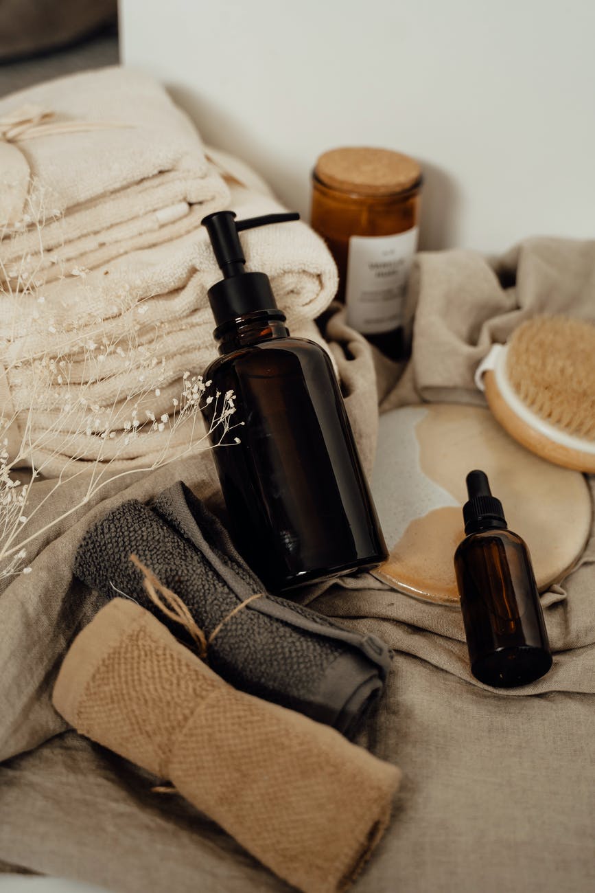 brown bottles and dispensers on folded towels