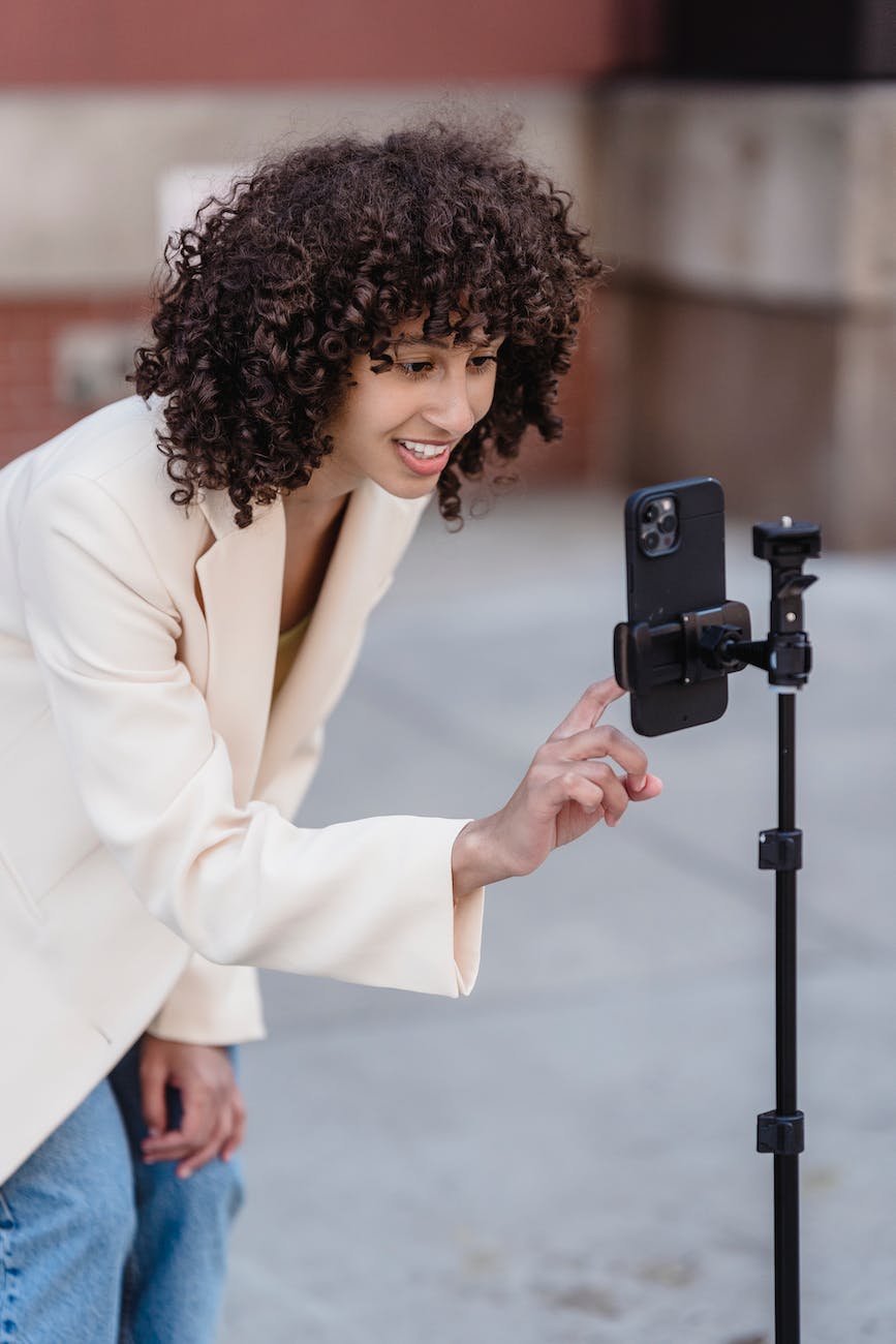 delighted ethnic woman doing live broadcast