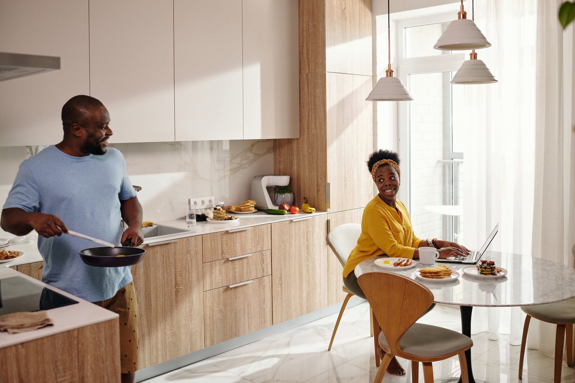 a couple having conversation in the kitchen