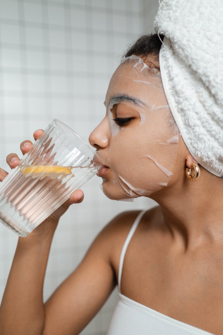 woman drinking water with lemon