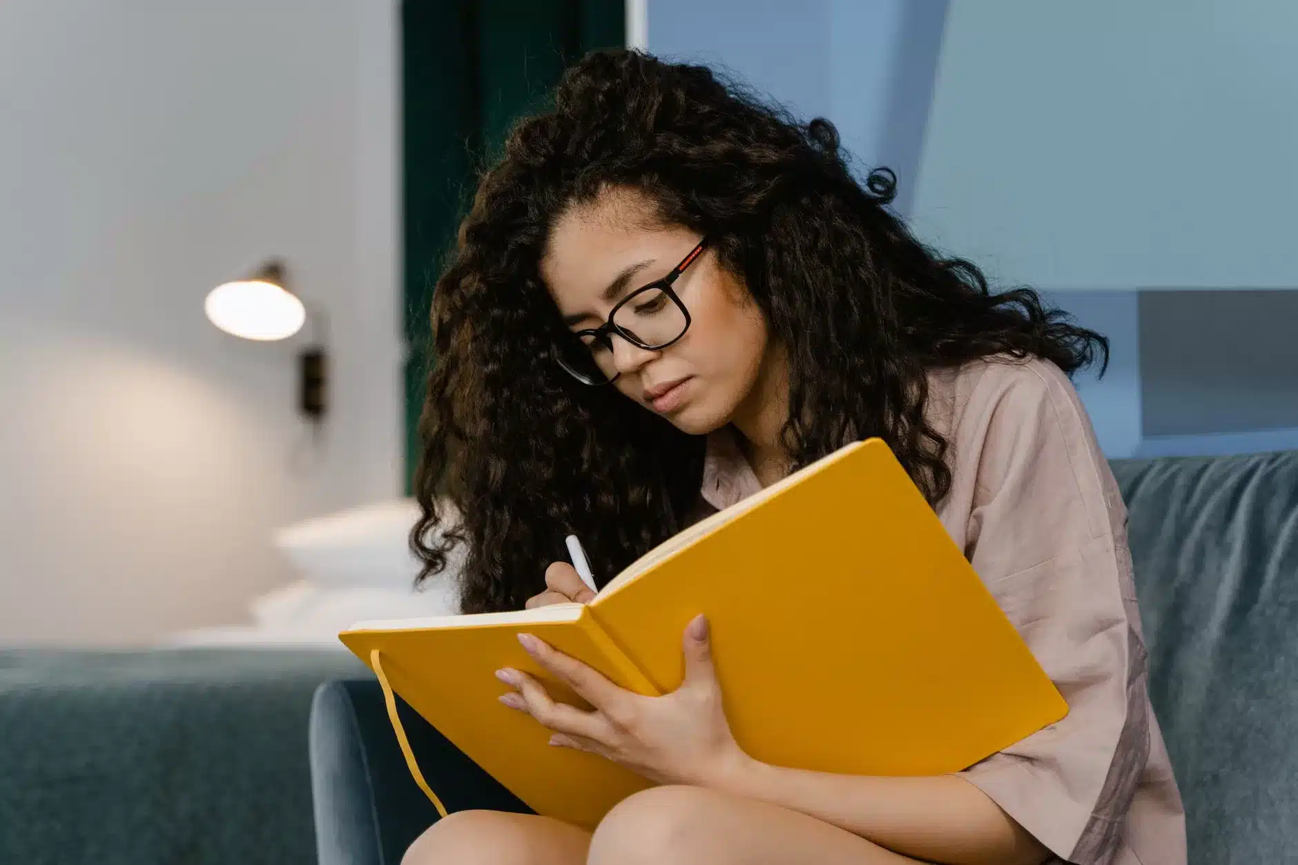 a young woman writing in a diary